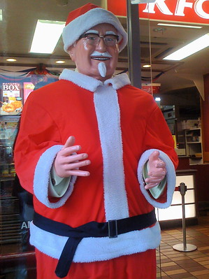Colonel Saunders dressed as Santa Claus at a KFC